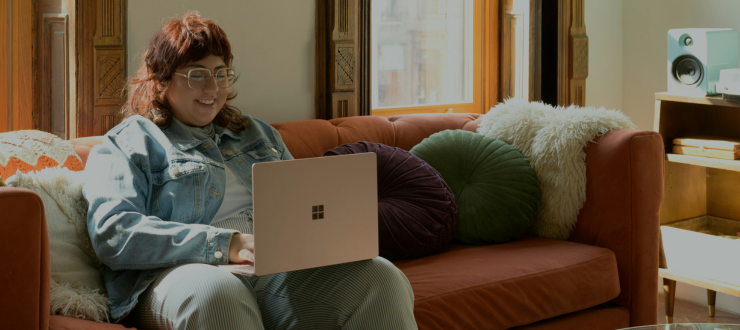 A customer using a laptop in their home to demonstrate how telecoms supplier can support customers with mental health problems